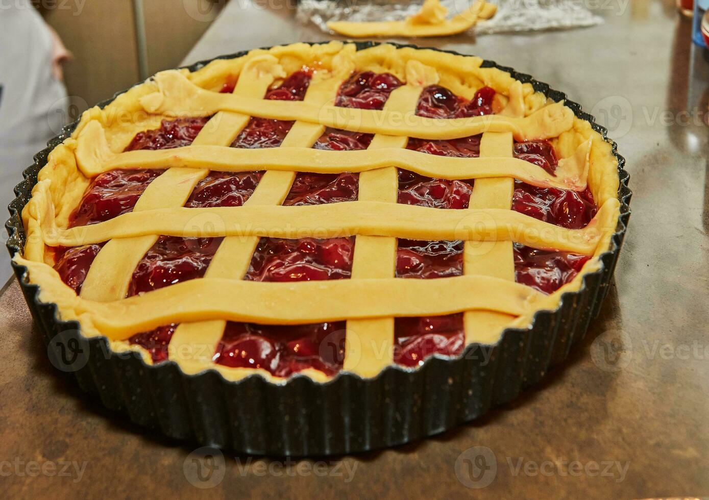 Chef makes cherry pie in his home kitchen photo