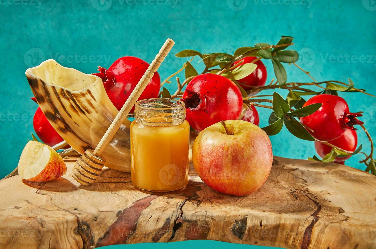 Rosh hashanah - jewish new year holiday concept. Bowl in the shape of an apple with honey, apples, pomegranates, shofar on a blue background. photo