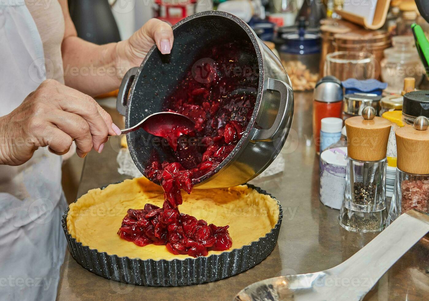 Chef makes cherry pie in his home kitchen photo