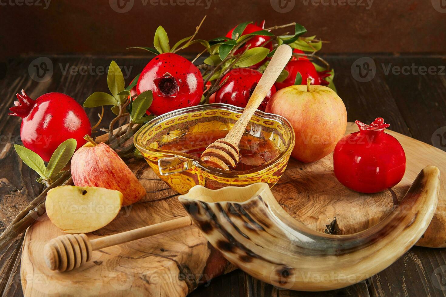 Rosh hashanah - jewish new year holiday concept. Bowl in the shape of an apple with honey, apples, pomegranates, shofar on wooden vintage background photo