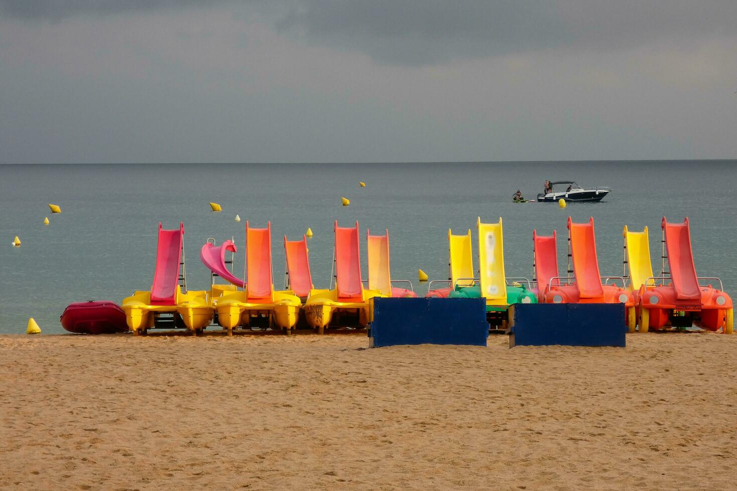 Kayaks and colorful sea skates on the beach photo