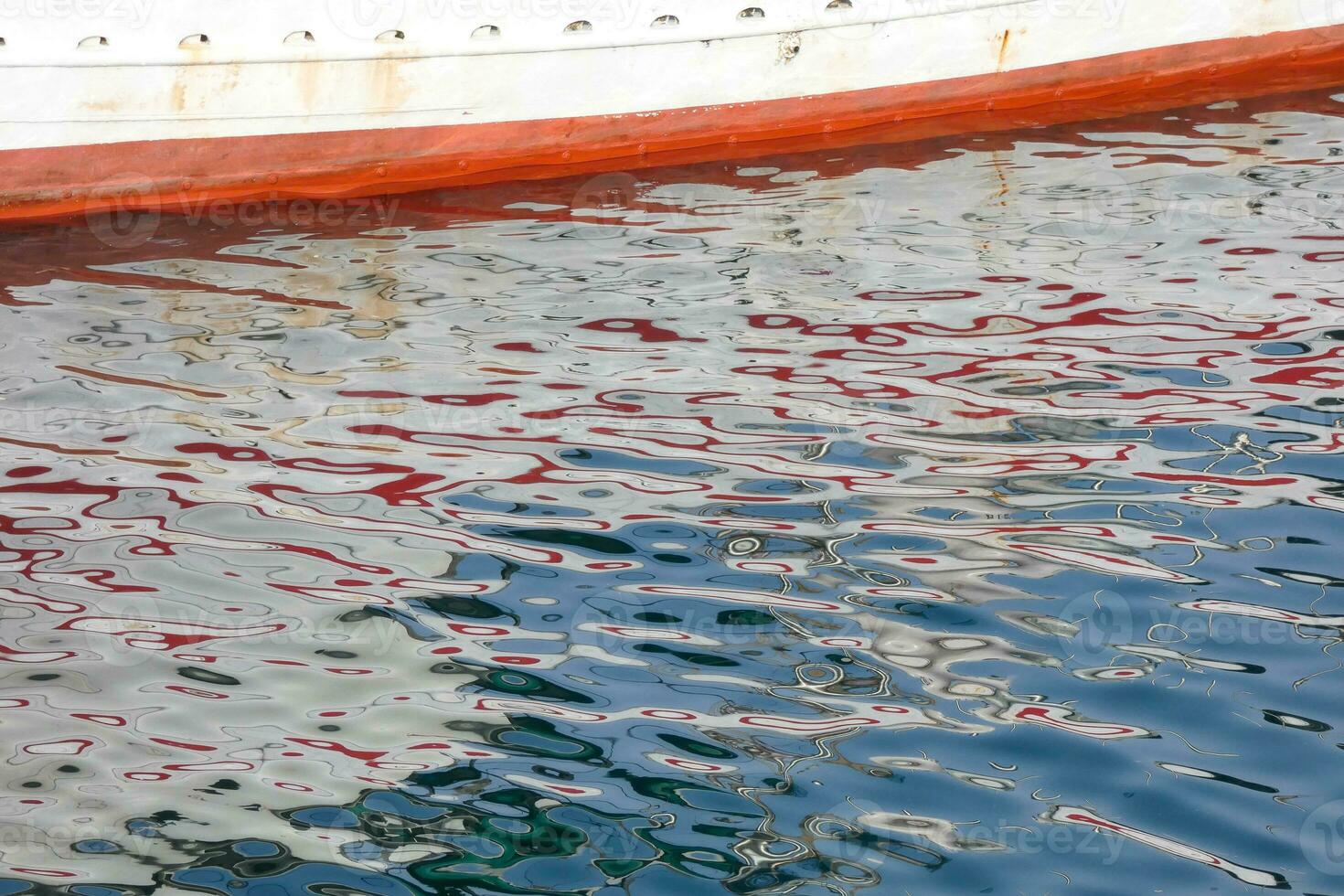 Colourful reflections in the water of a fishing port photo