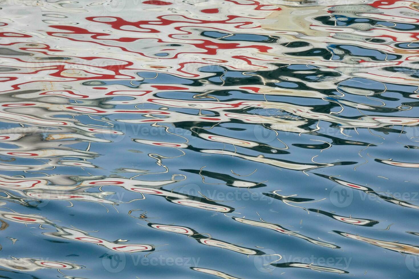 Colourful reflections in the water of a fishing port photo
