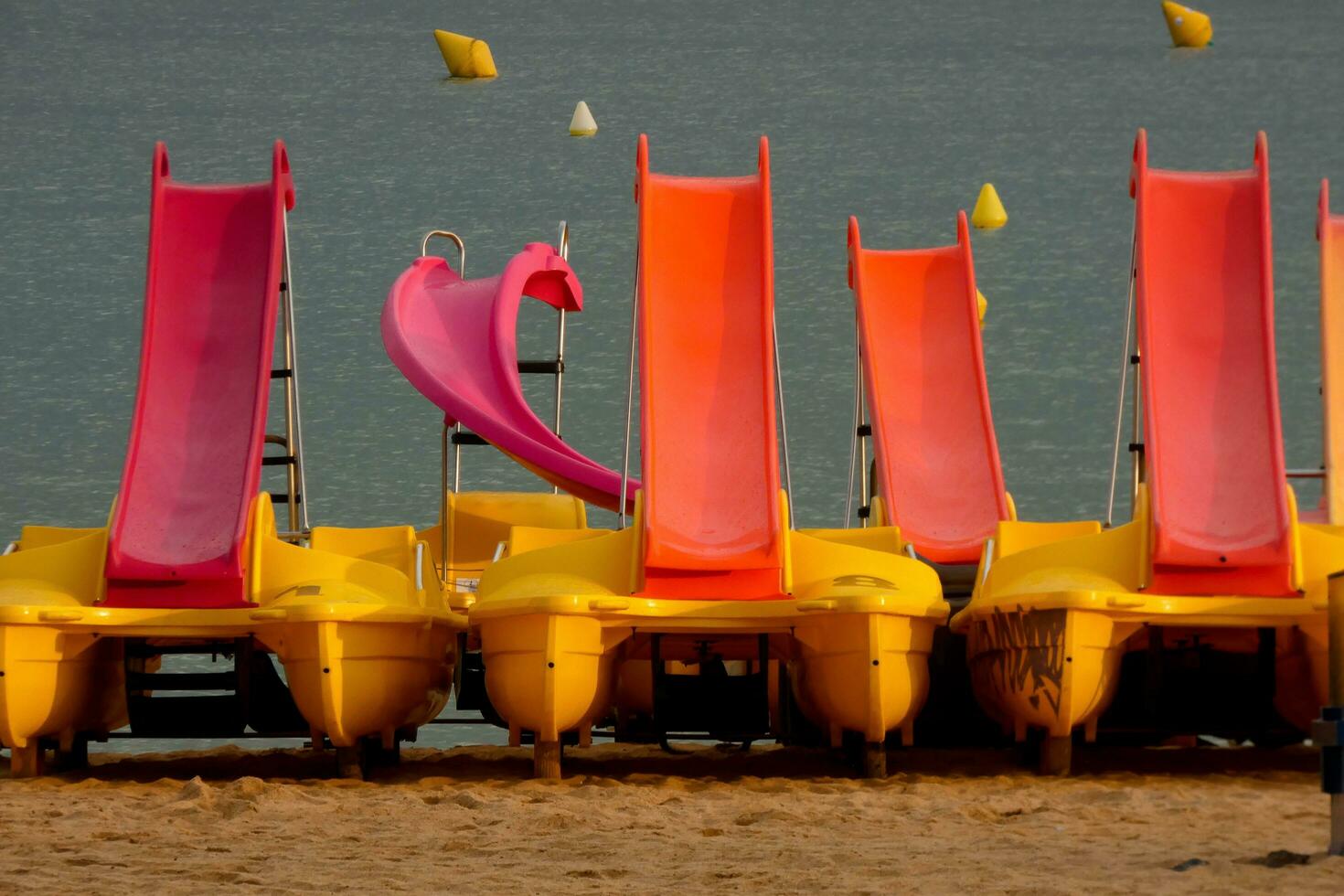 Kayaks and colorful sea skates on the beach photo