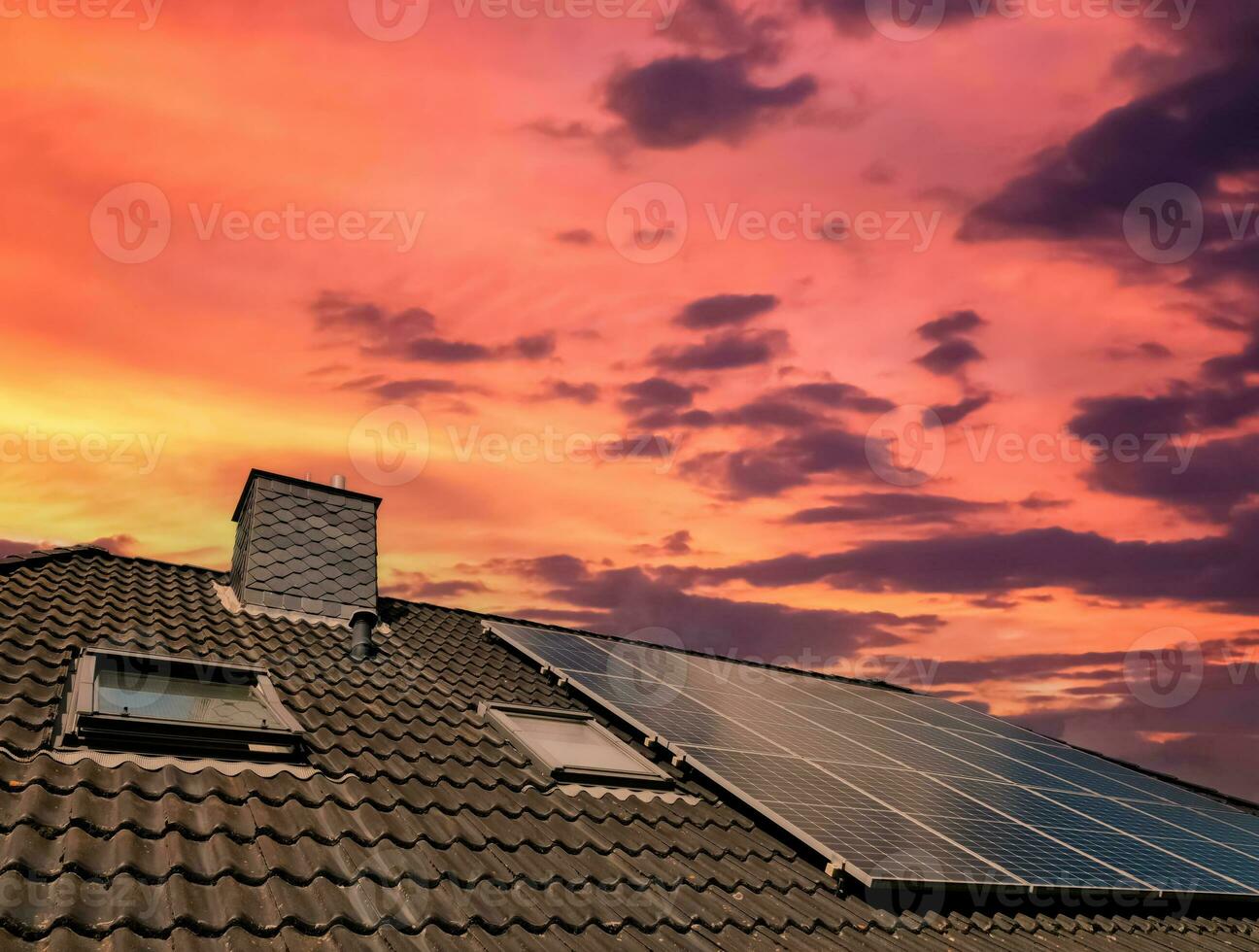 Solar panels producing clean energy on a roof of a residential house photo
