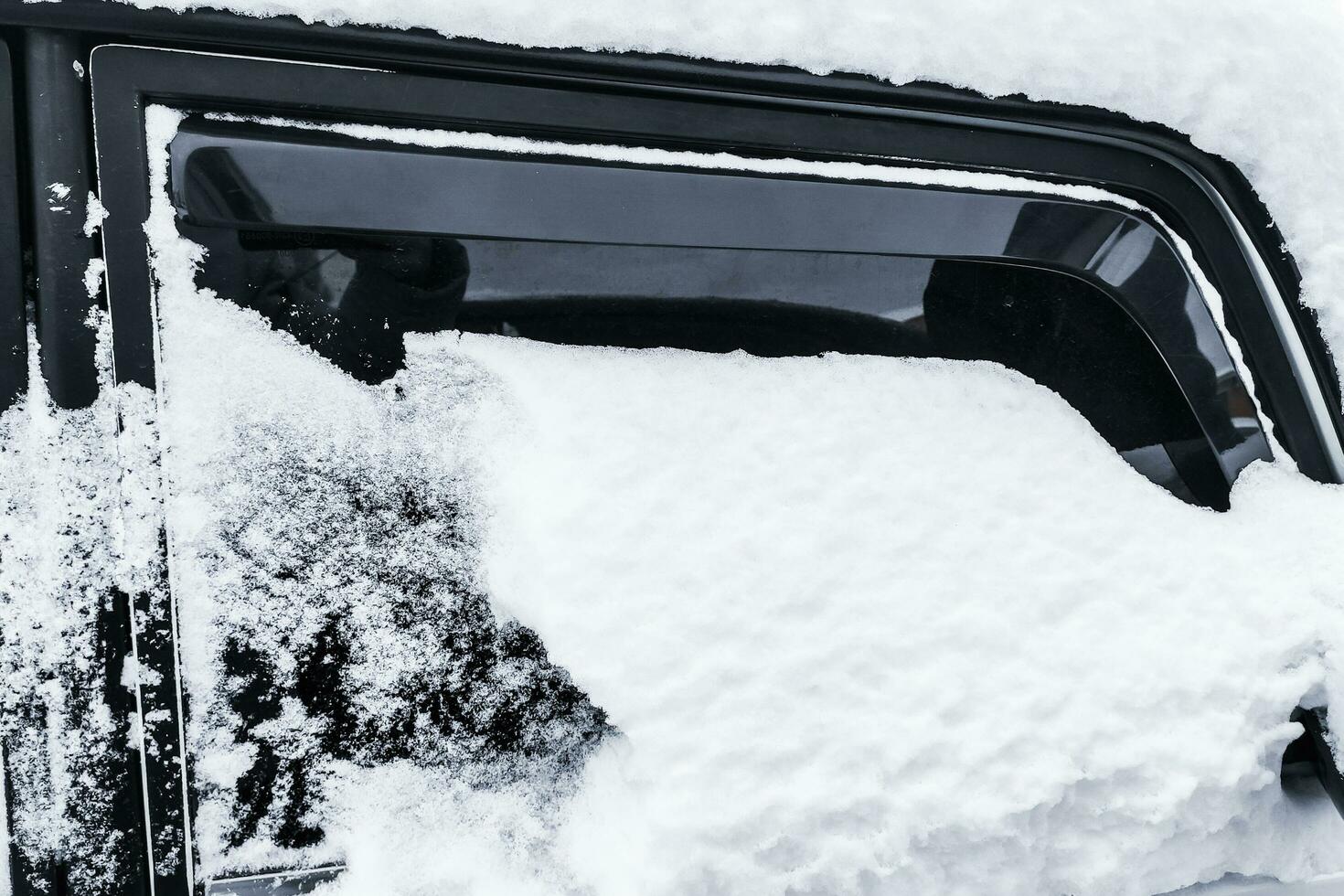 Car in winter in the snow, Cleaning the car photo