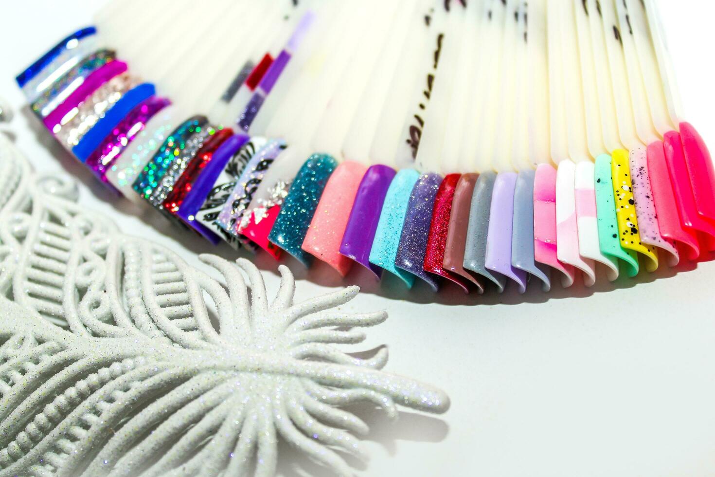 Palette of nail designs, testers of multicolored polishes on flat nails photo