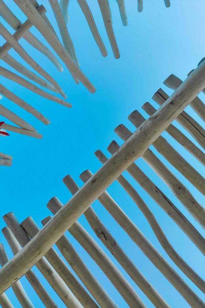 The roof of a tropical bungalow against the background of the sky, protection from the sun photo