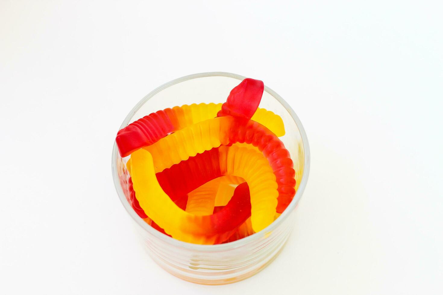 Sweet jelly worms on a light background photo