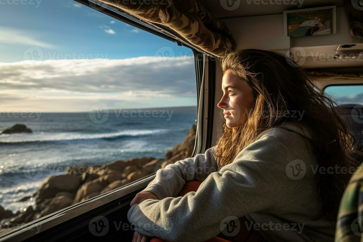 Young woman in her camper enjoying a scenic beach view, a tranquil moment of wanderlust and adventure. Generative AI photo