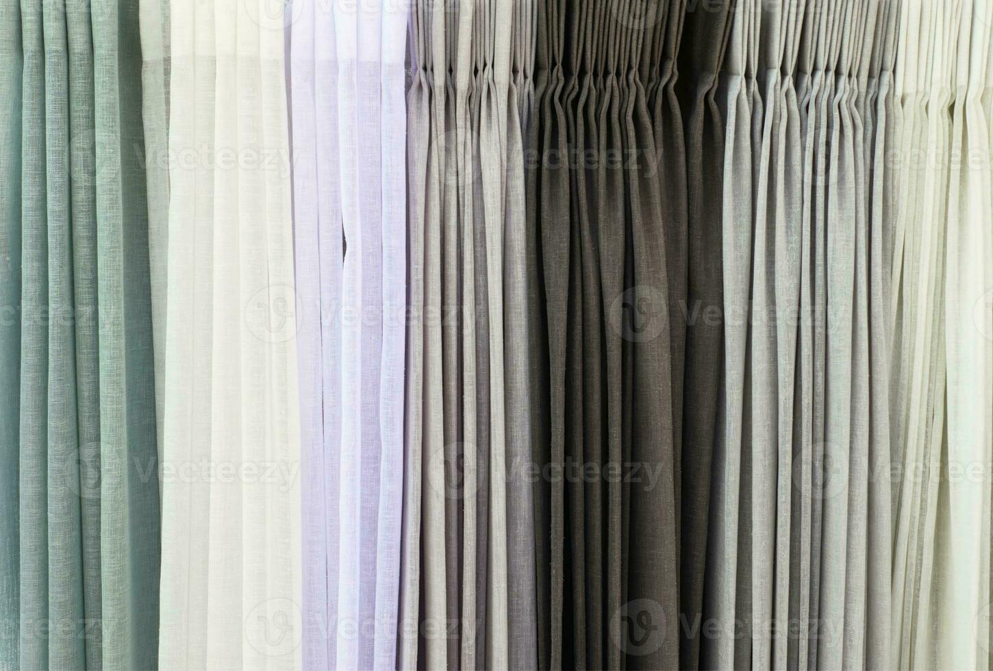 Detailed close up view on samples of cloth and fabrics in different colors found at a fabrics market photo