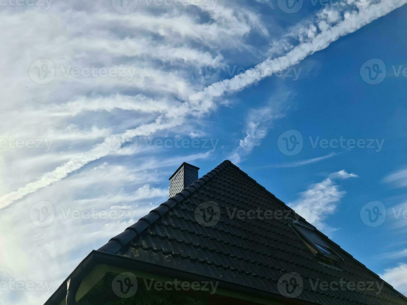 Open roof window in velux style with black roof tiles. photo