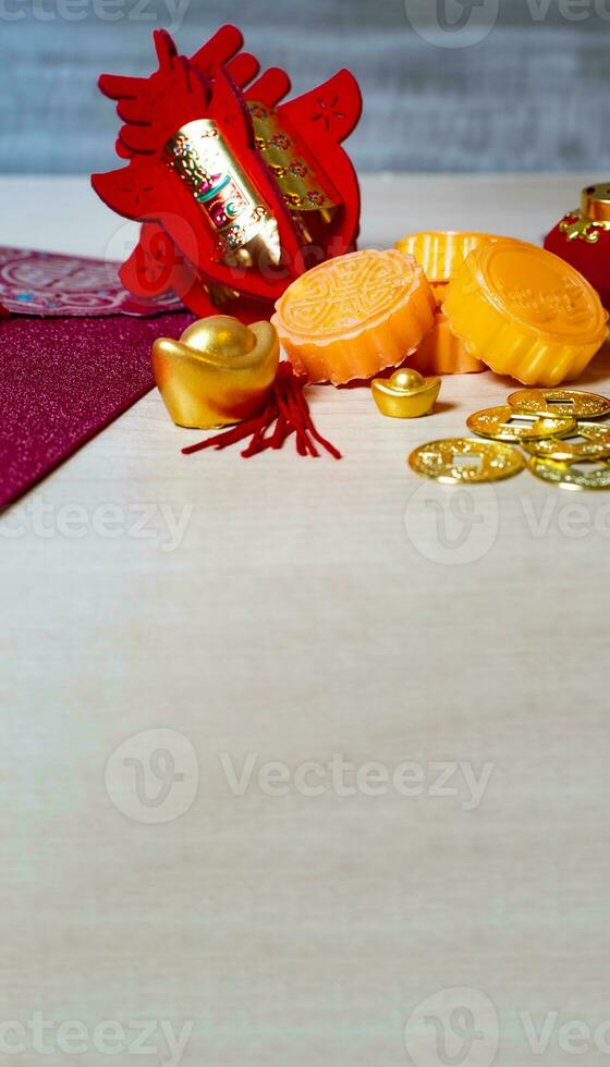 Mooncakes, tea pot and cups on wooden background. photo