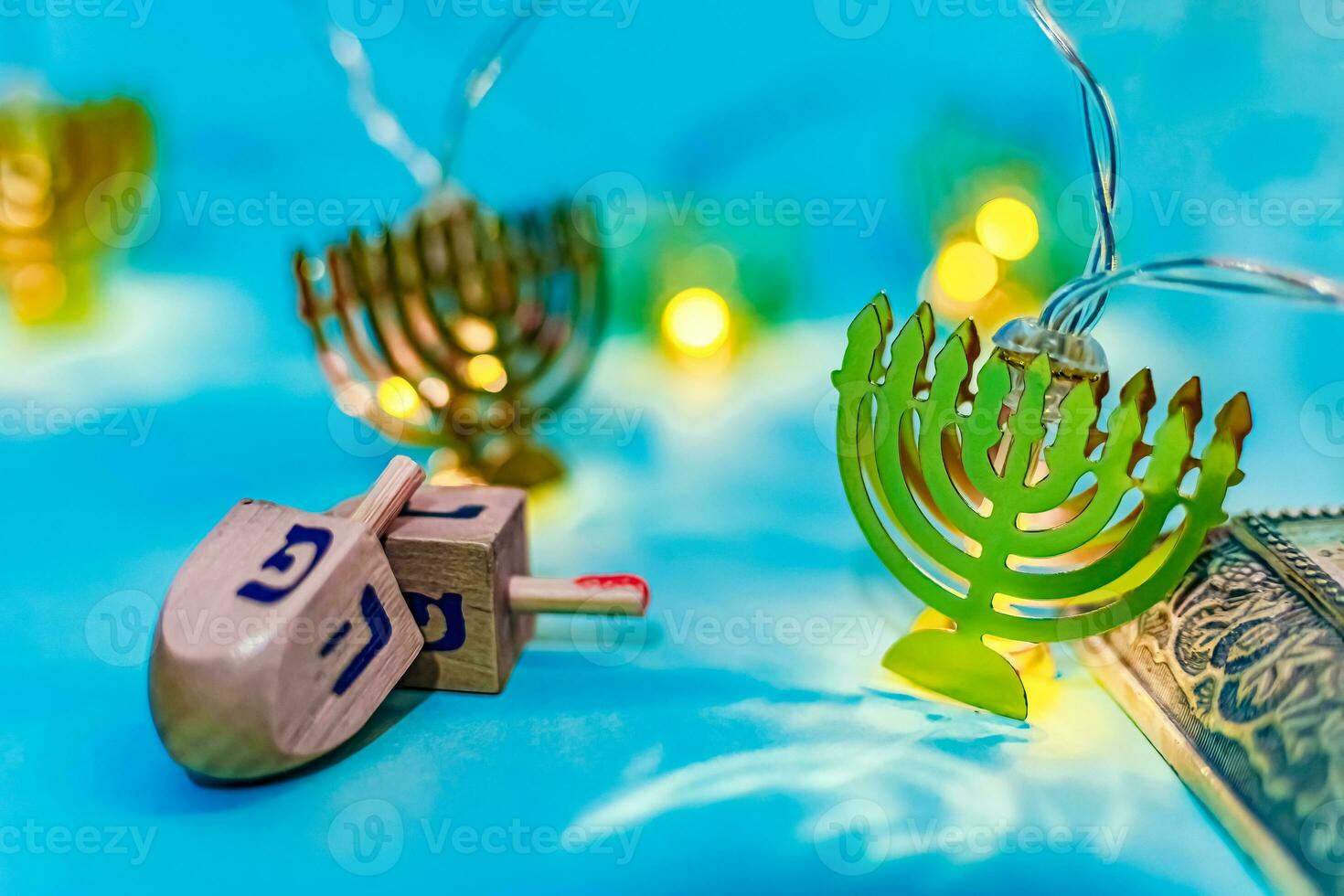 Close up of dreidel and menorah yellow Hanukkah. photo