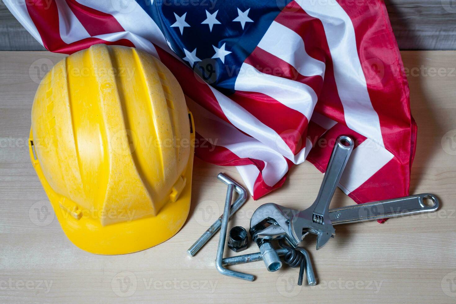 Labor Day holiday concept with USA flag and many worker tools. photo