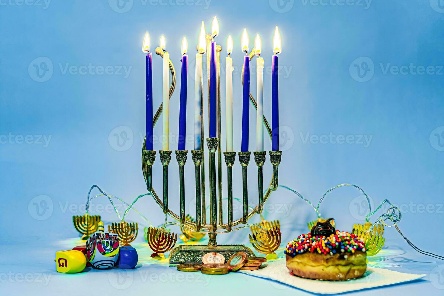 Traditional Hanukkah sweets with candles. photo