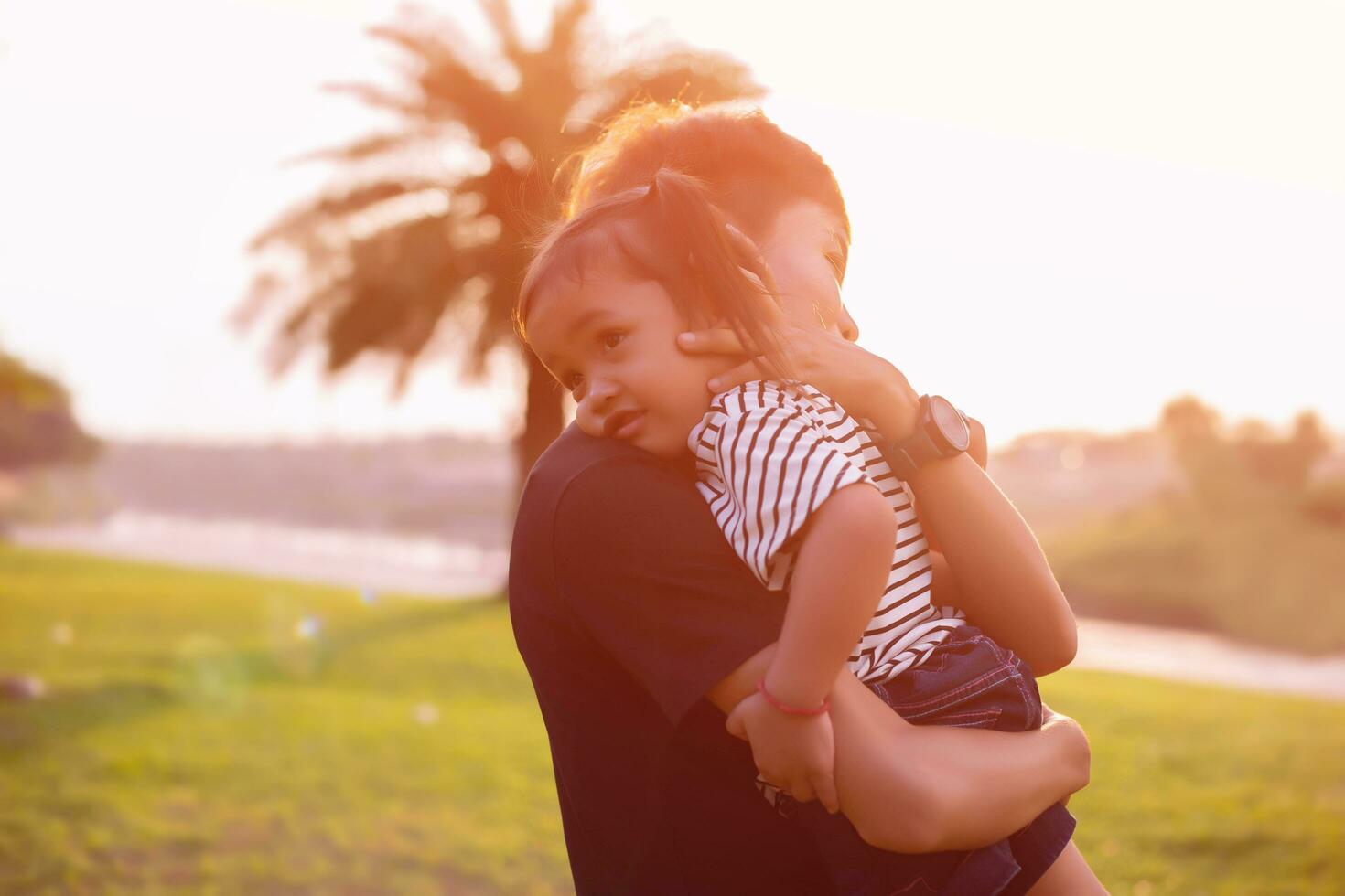 Happy harmonious family outdoors. mother throws baby up, laughing and playing in the summer on the nature.SSTKHome photo