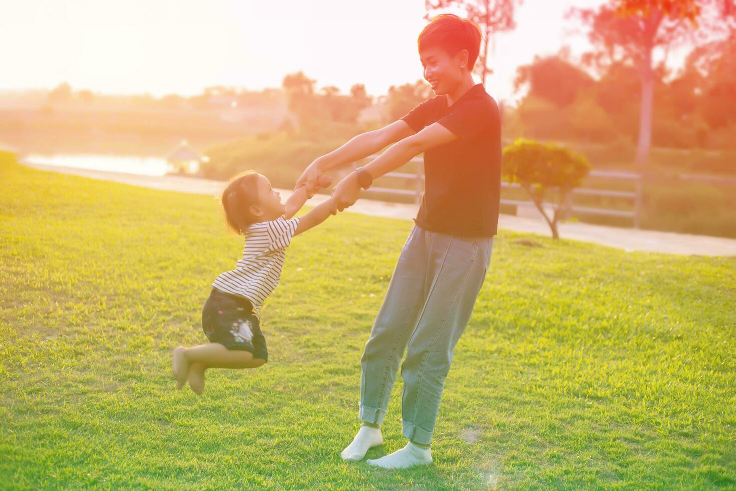 Happy harmonious family outdoors. mother throws baby up, laughing and playing in the summer on the nature.SSTKHome photo