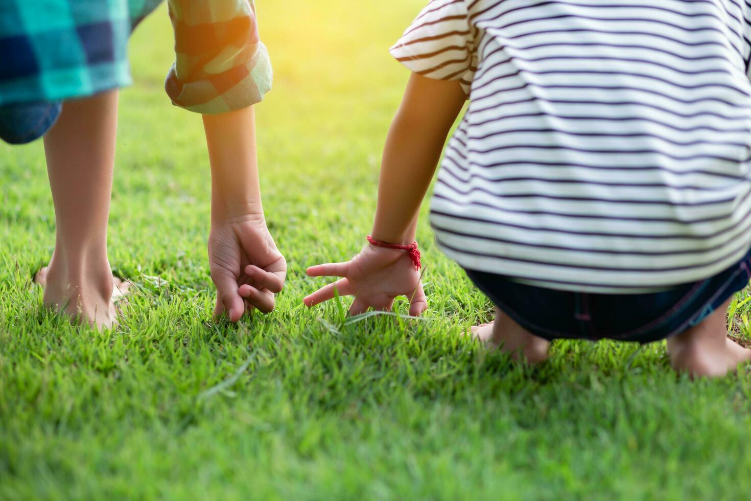 Profile view of cute kids run in park hold hands.SSTKHome photo