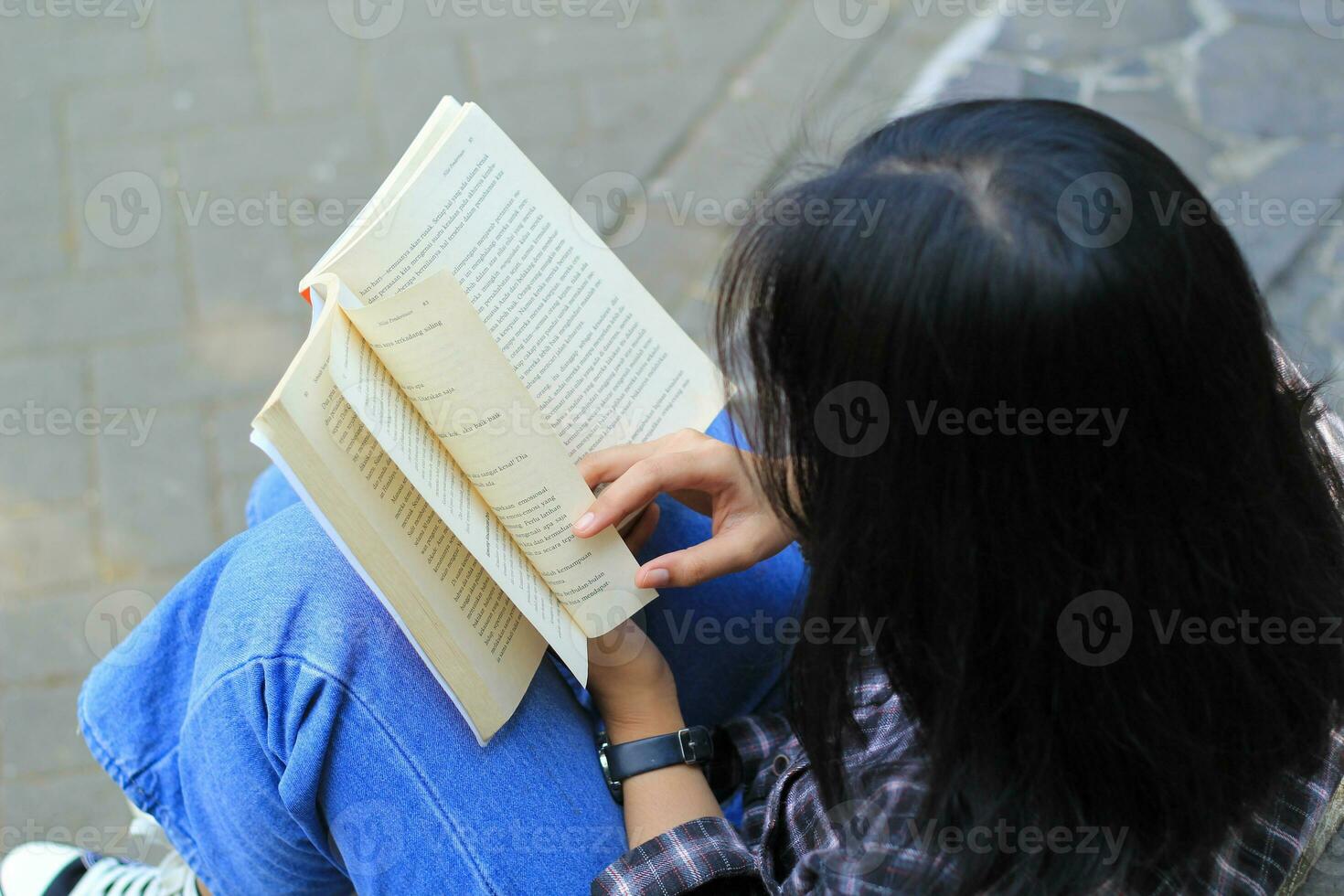 happy mindful young asian woman college student reading a book in the park, education concept photo