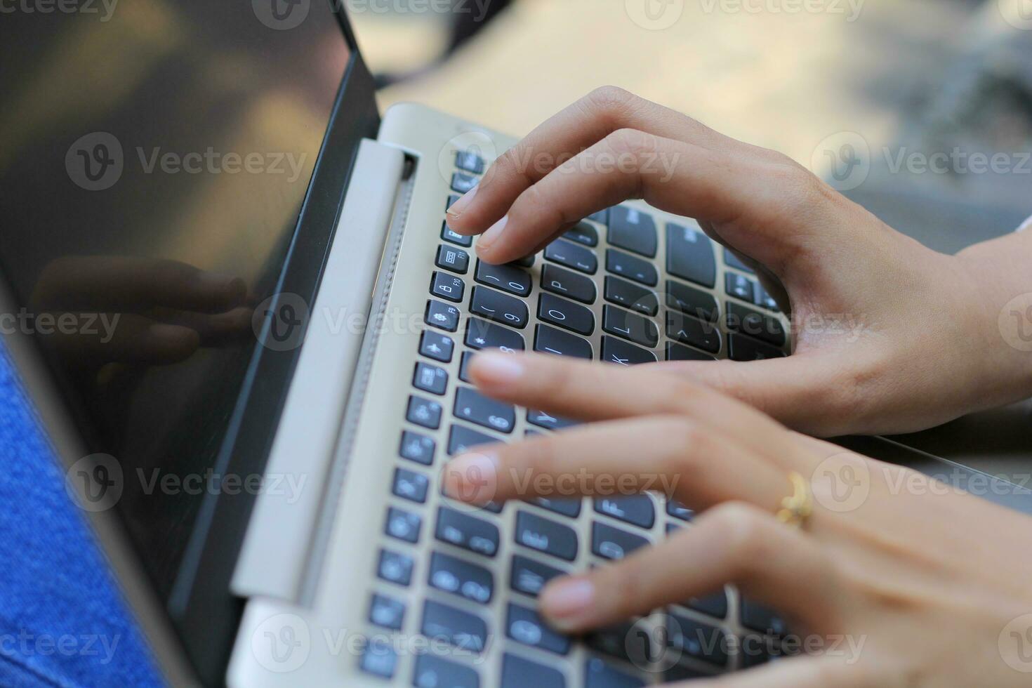 businesswoman hands typing on laptop keyboard close up photo