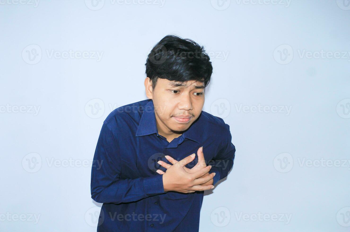 heart attack, asian office worker holding his chest suffering from heart pain caused stressful job. isolated white photo