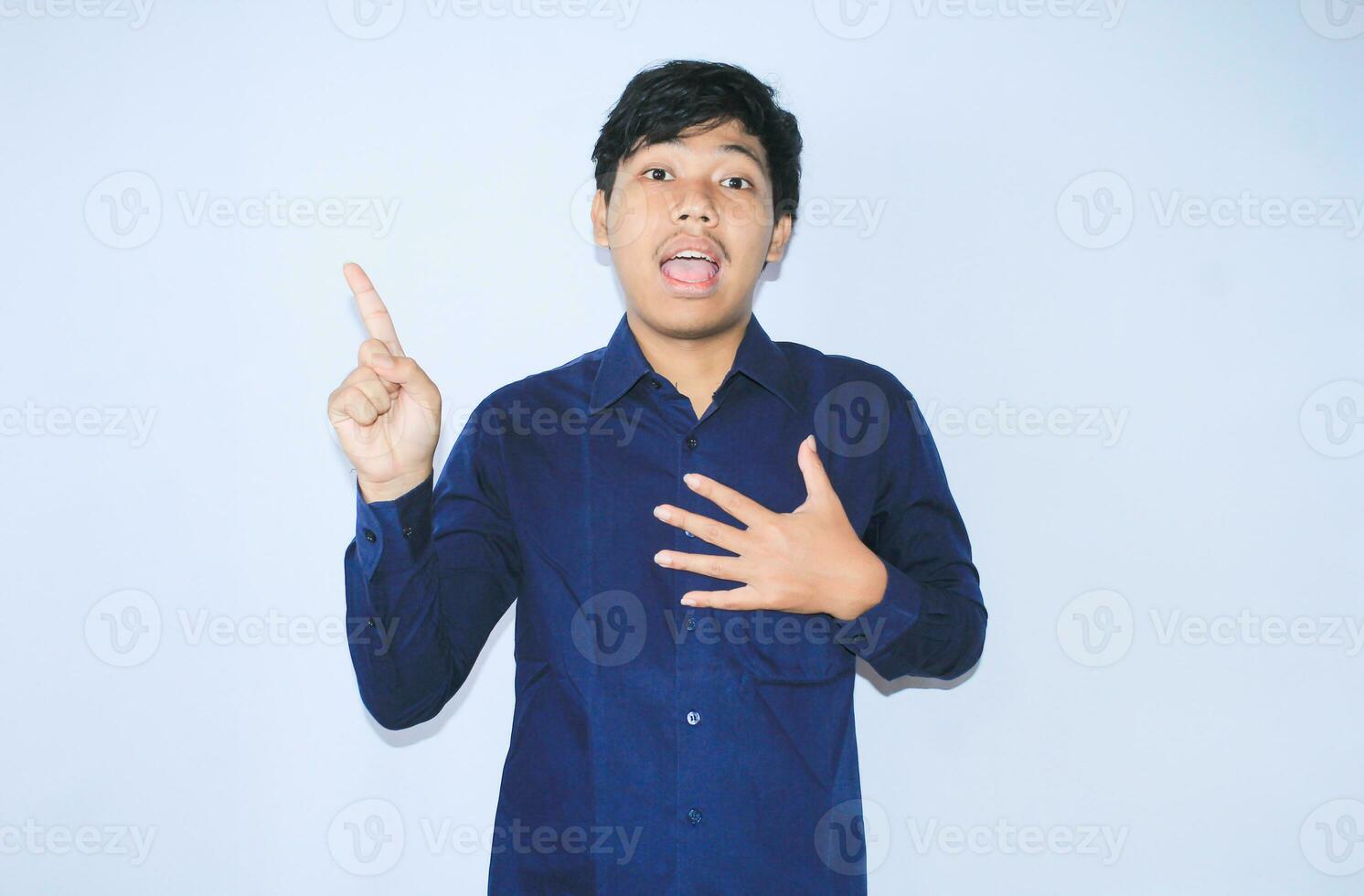 gratefull asian businessman is  smiling after suffering from heart attack show presenting gesture with pointing finger up photo