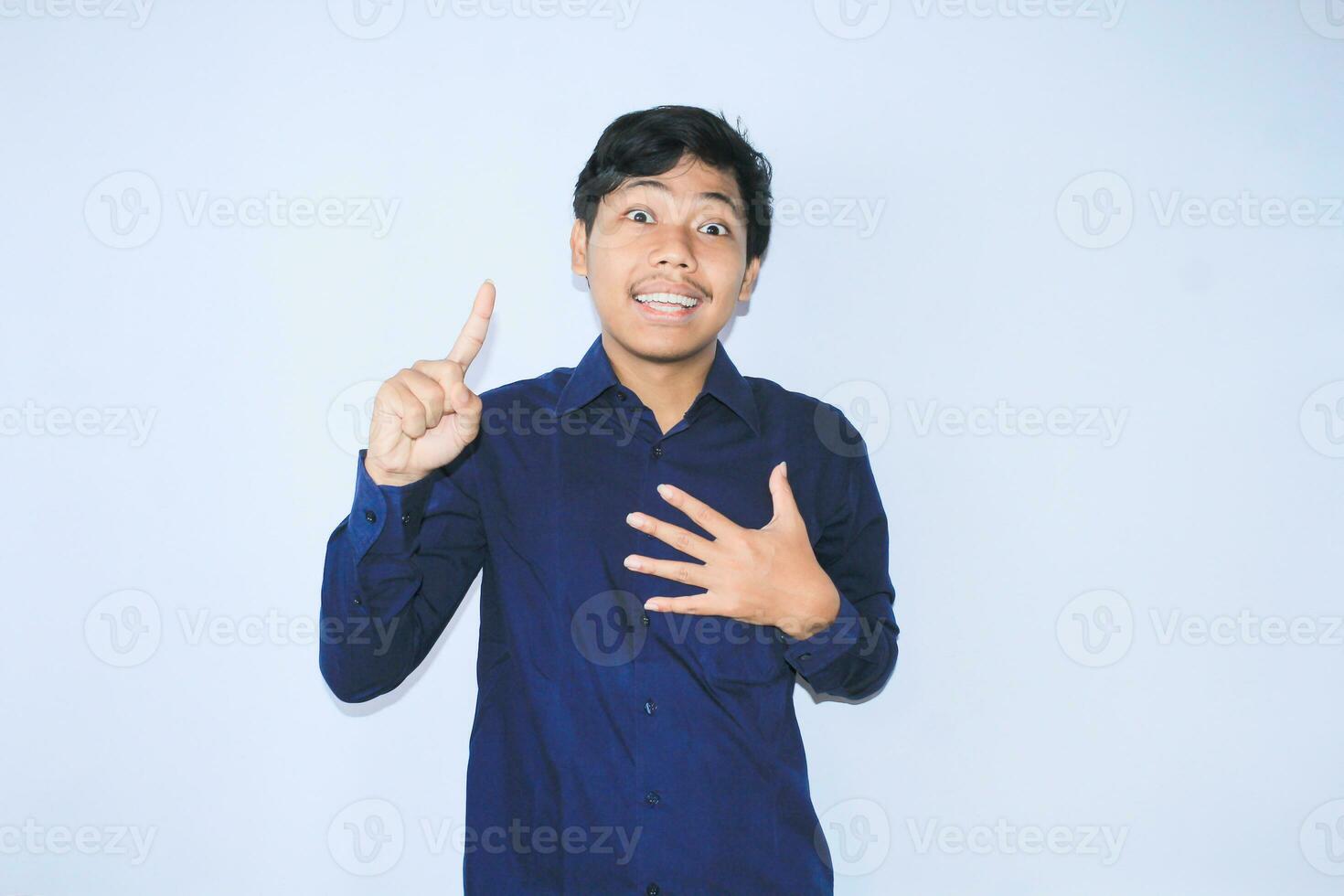 gratefull asian businessman is  smiling after suffering from heart attack show presenting gesture with pointing finger up photo