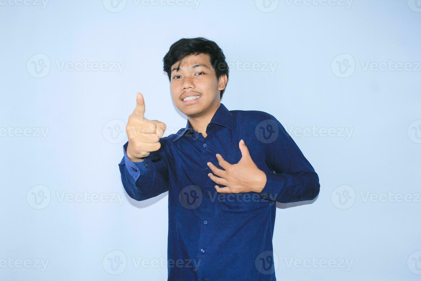 gratefull asian businessman is  smiling after suffering from heart attack show presenting gesture with pointing finger to camera photo