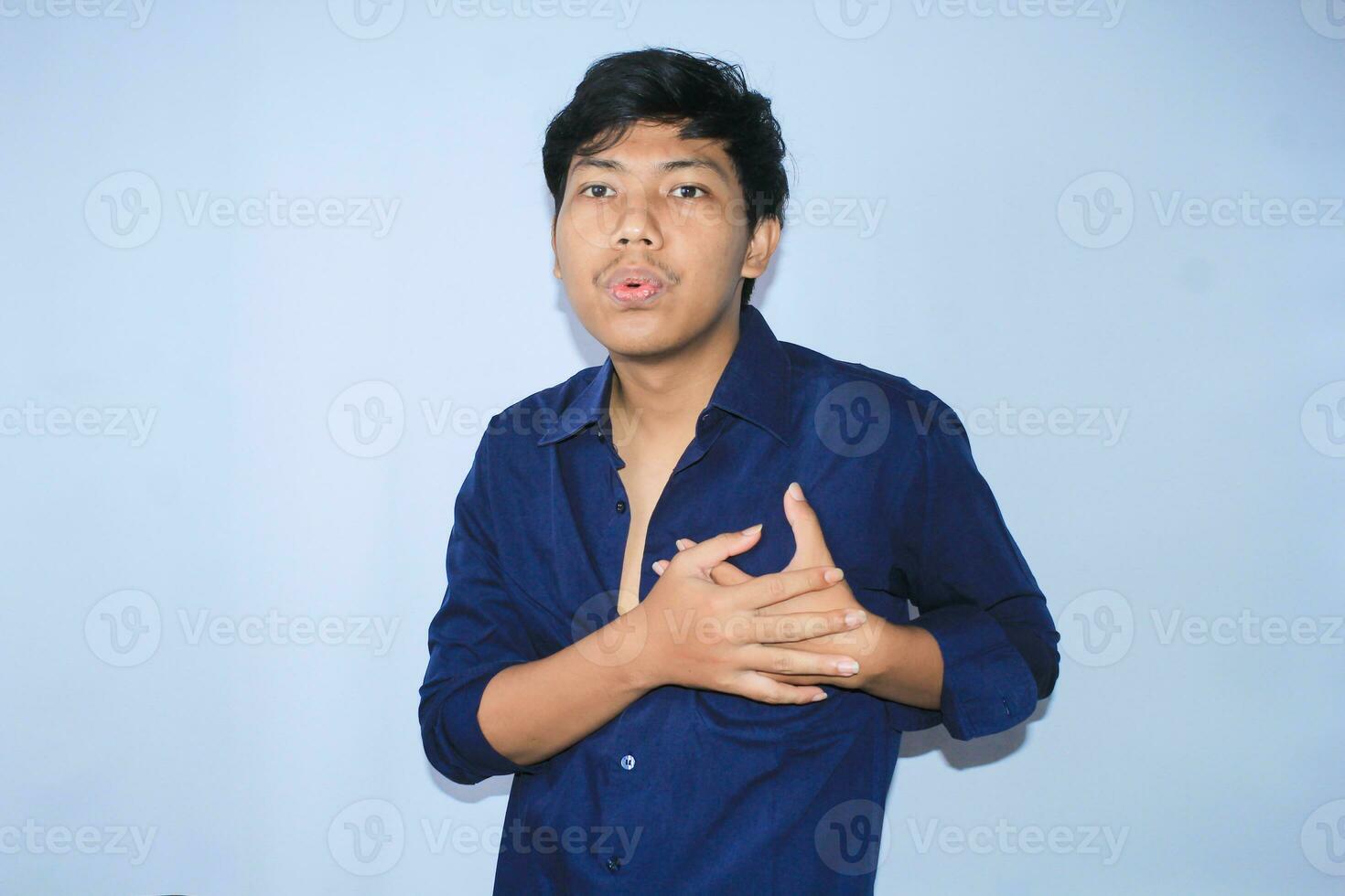 heart attacked asian young man is relaxing and breathing aslo inhale and exhale with two hands hold pain in the chest photo