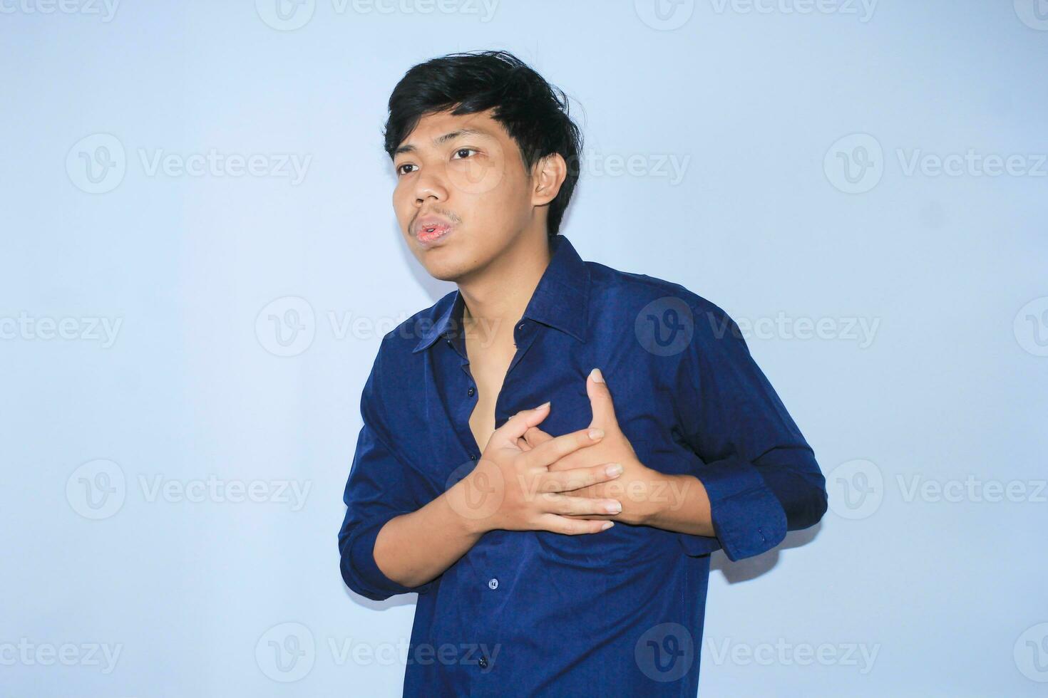 heart attacked asian young man is relaxing and breathing aslo inhale and exhale with two hands hold pain in the chest photo