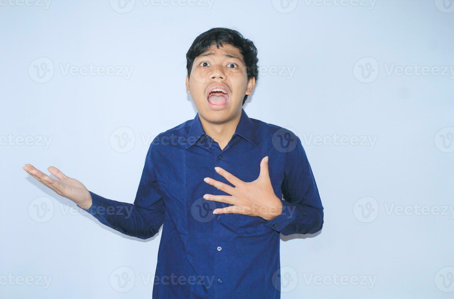 screaming asian businessman suffering from heart attack pain by touching his chest with showing do not know gesture and presenting photo