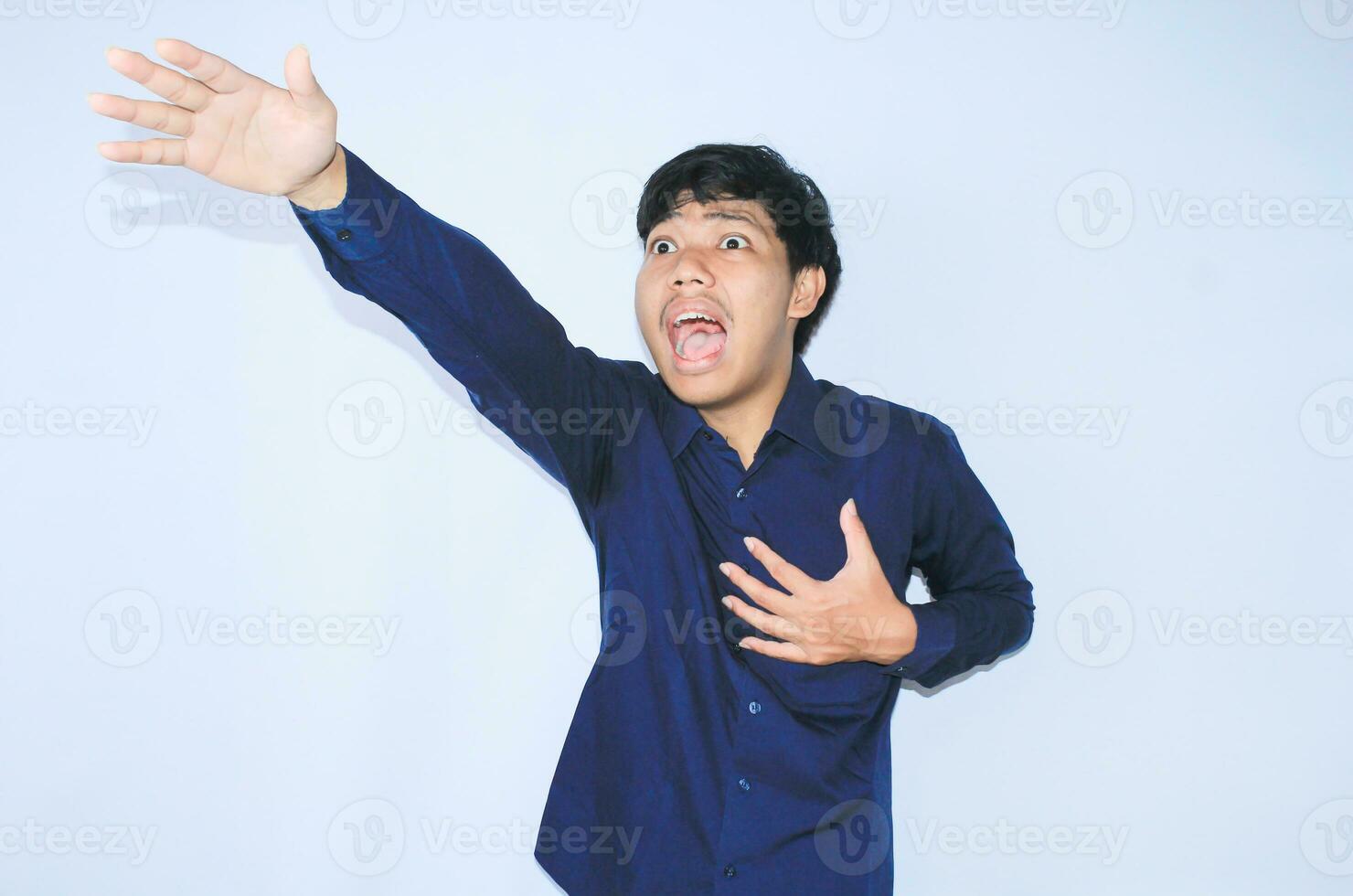 heart attacked asian man office worker screaming and touch his chest with gesture reaching out for help suffering from heart pain, wear navy shirt photo