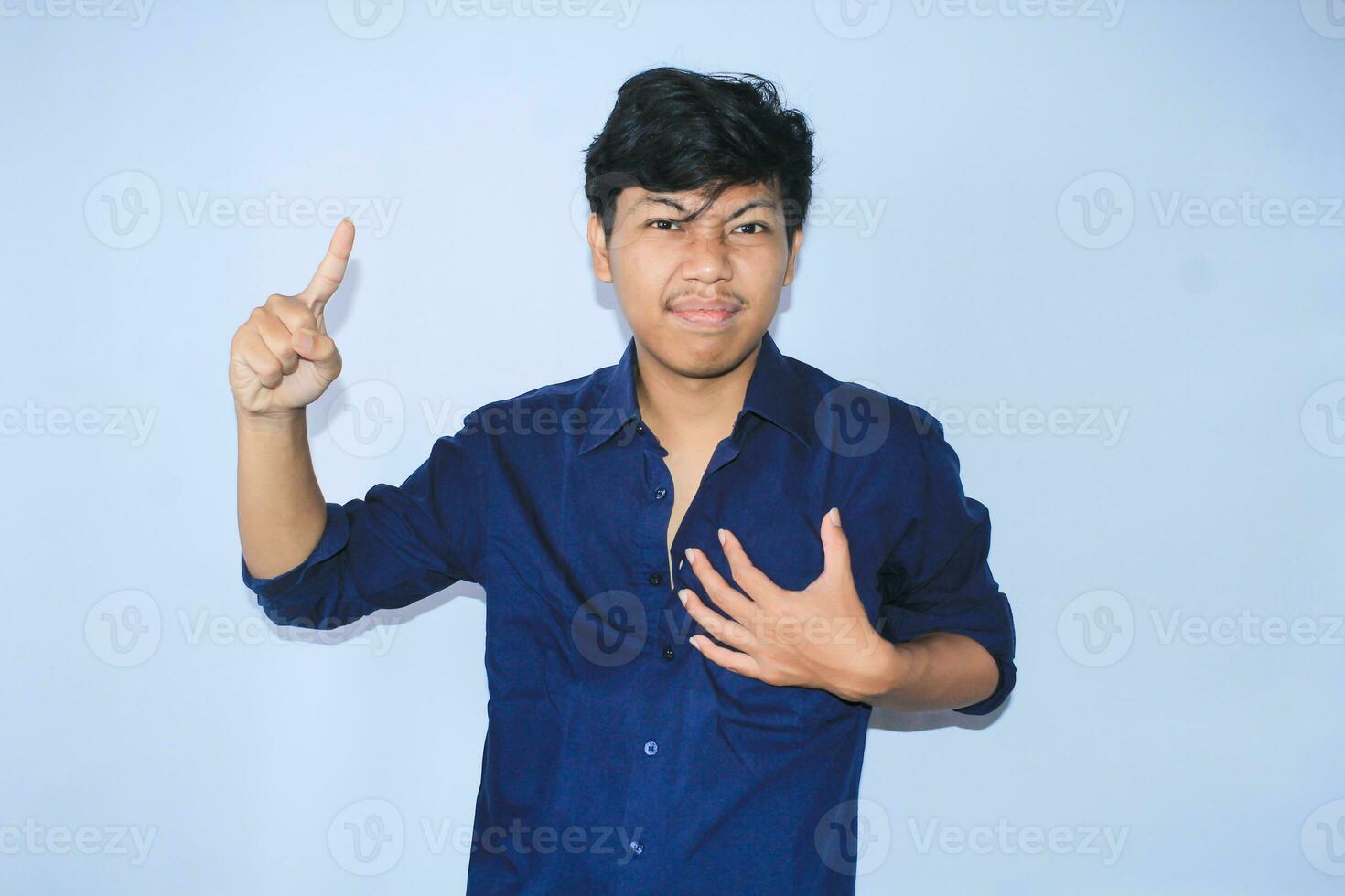 gratefull asian businessman is  smiling after suffering from heart attack show presenting gesture with pointing finger up photo