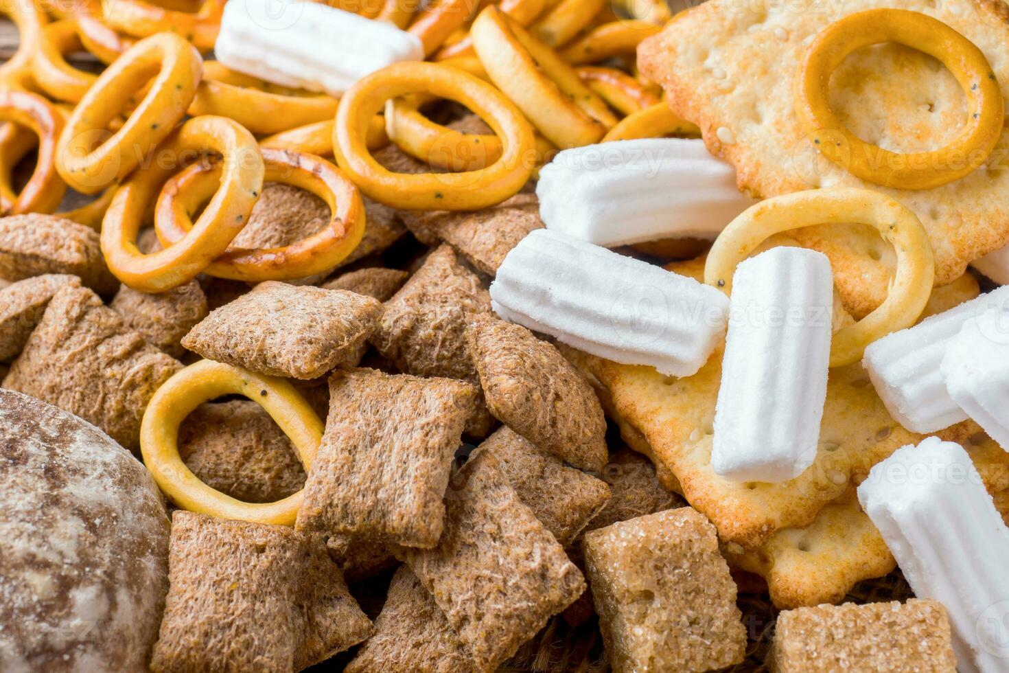 Assortment of cereal confectionery, marshmallow drying cookies on wooden background. photo