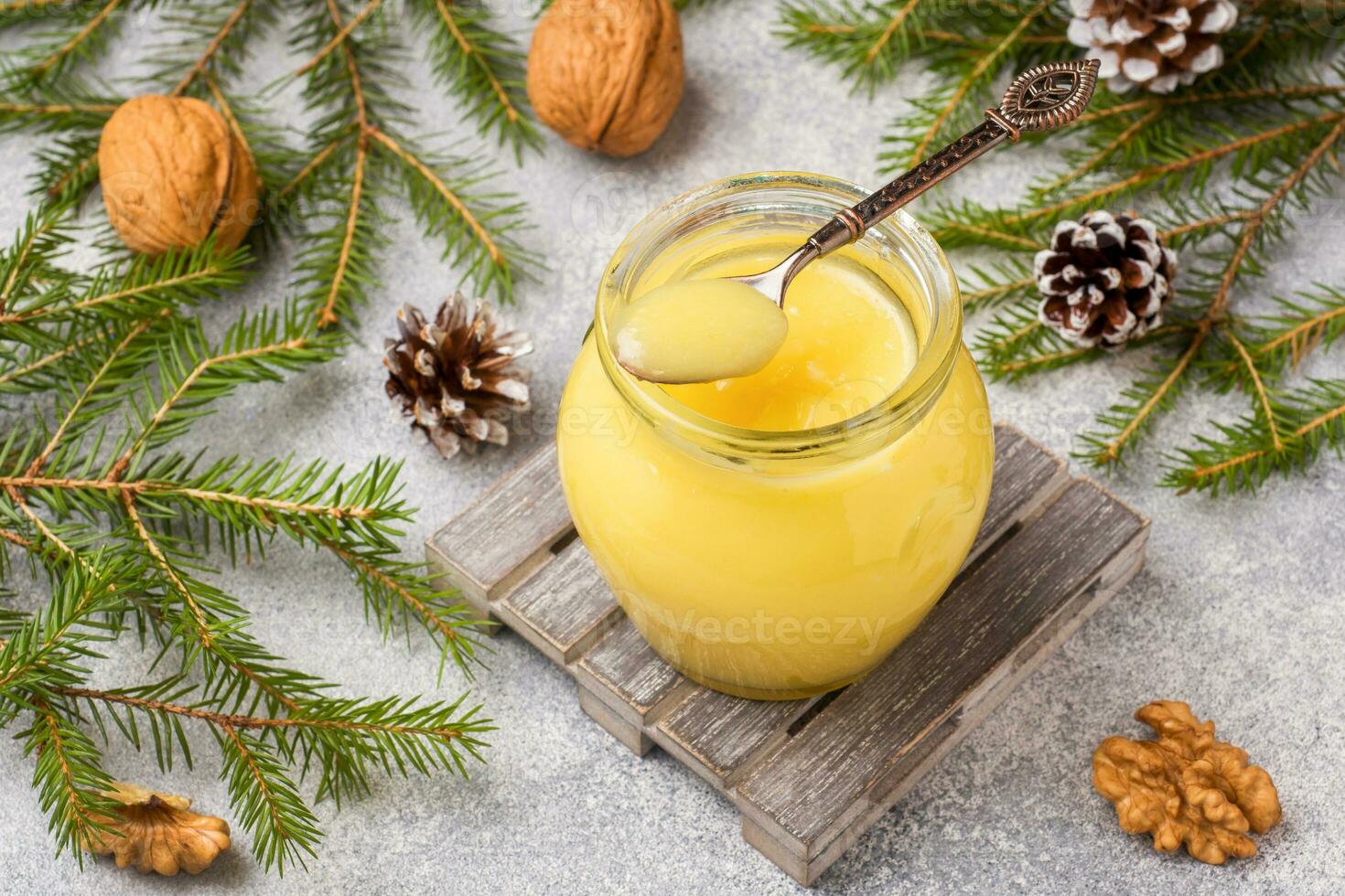 Homemade lemon curd in glass jars on the table. Concept Christmas photo