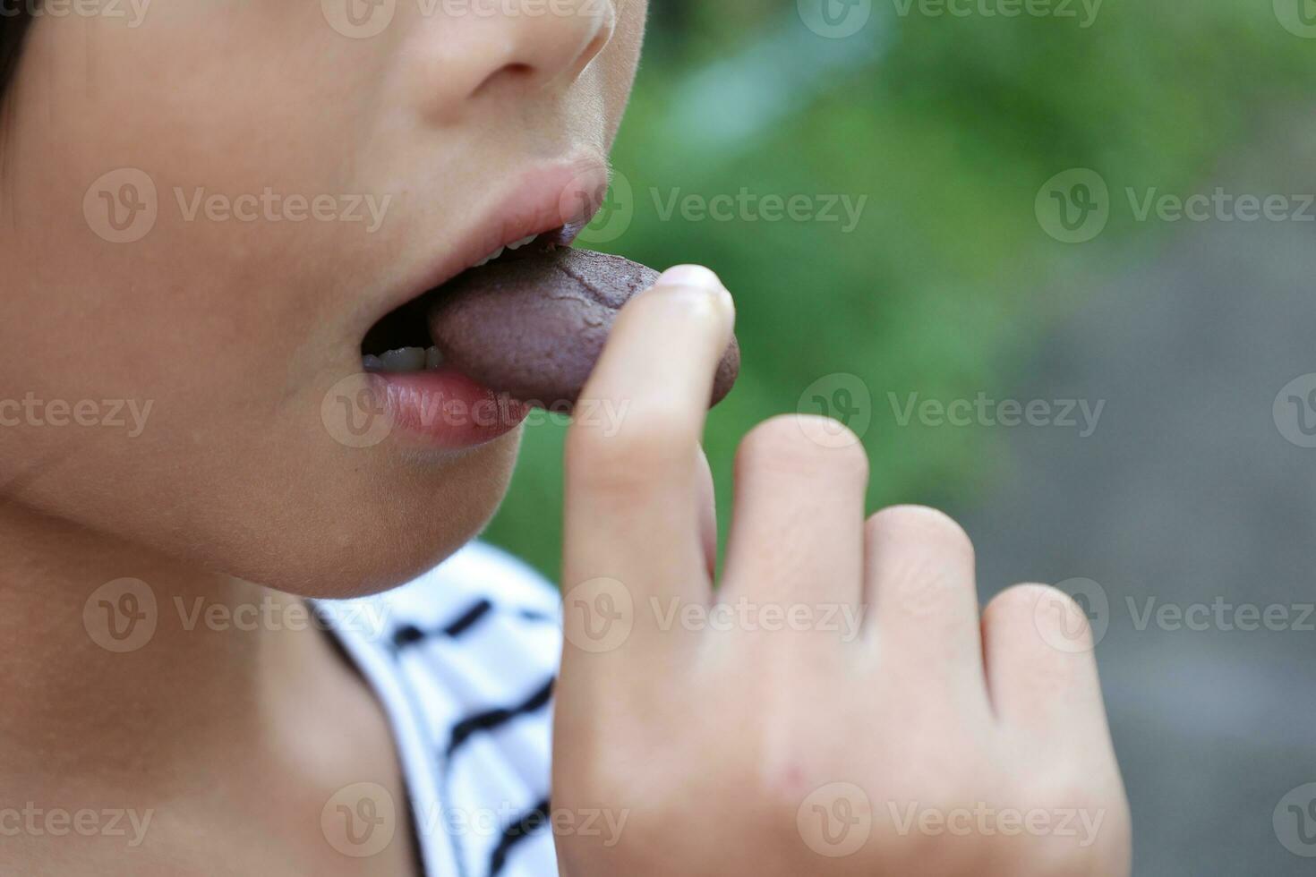 Close-up view of mouth eating food photo