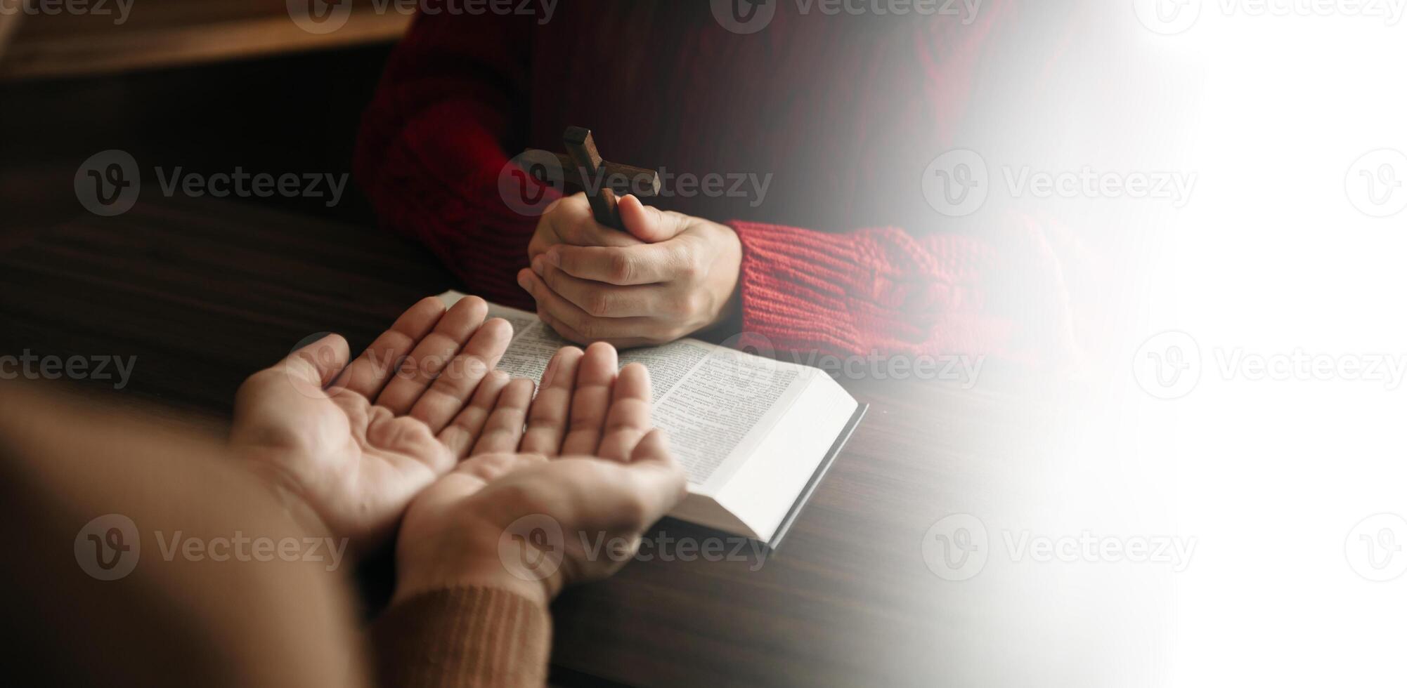 Two people reading and study bible in home and pray together.Studying the Word Of God With Friends. in sun light photo