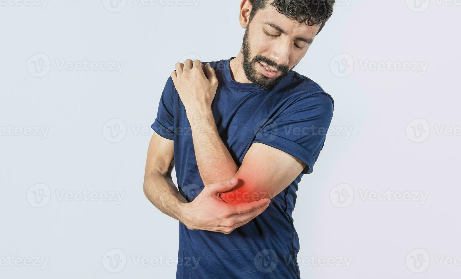 Person with elbow pain, concept of a man with rheumatism elbow pain, man massaging sore elbow, man with elbow cramp photo