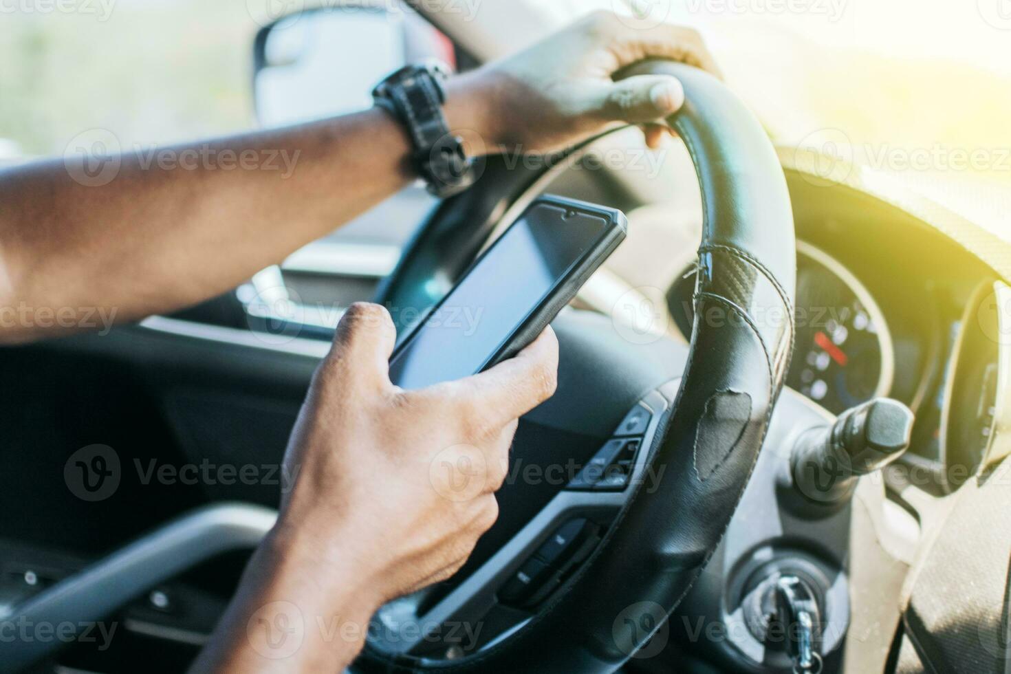 Person in his car using cell phone, Close up of driver hands using his phone, Concept driver hands touching cell phone screen photo