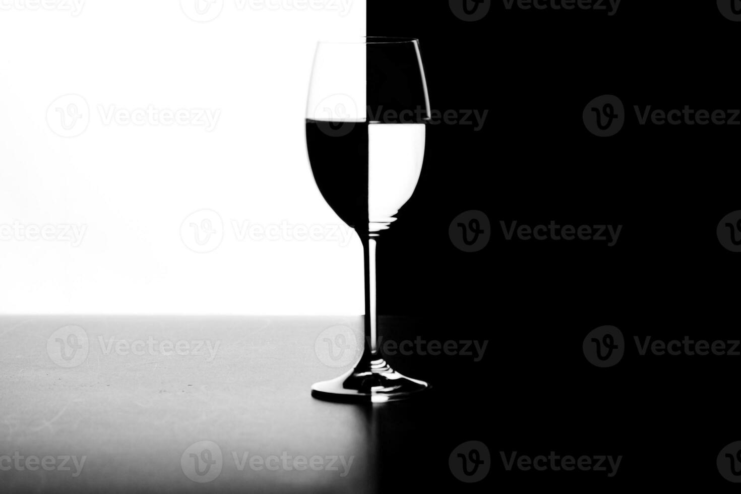 a glass of water and smoke on a black and white background photo