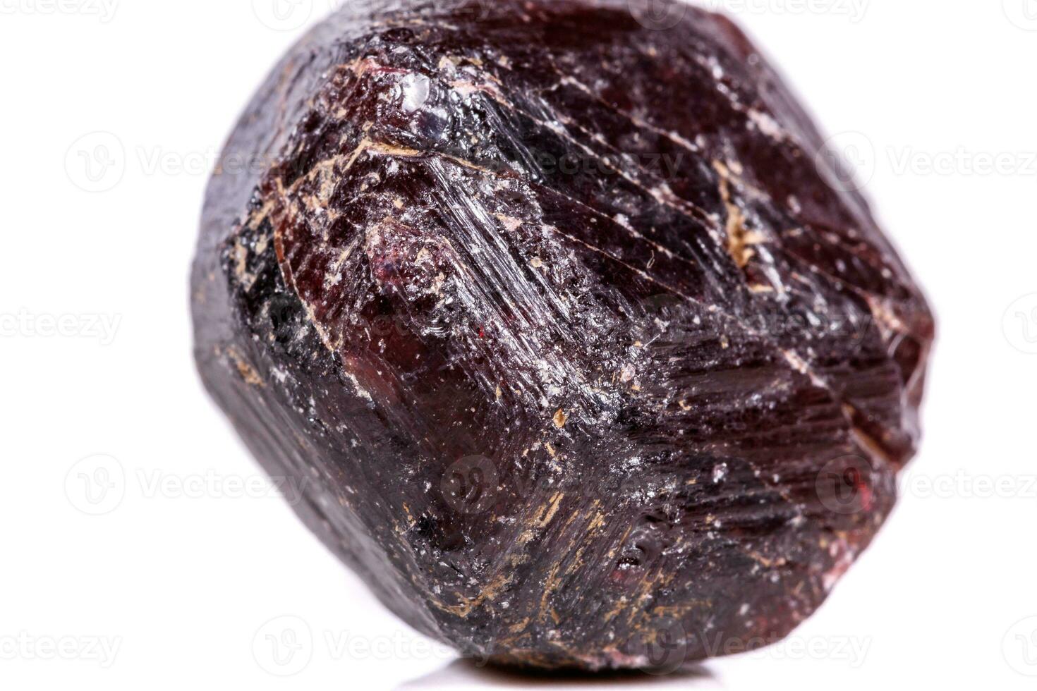 Macro of a mineral garnet stone on a white background photo