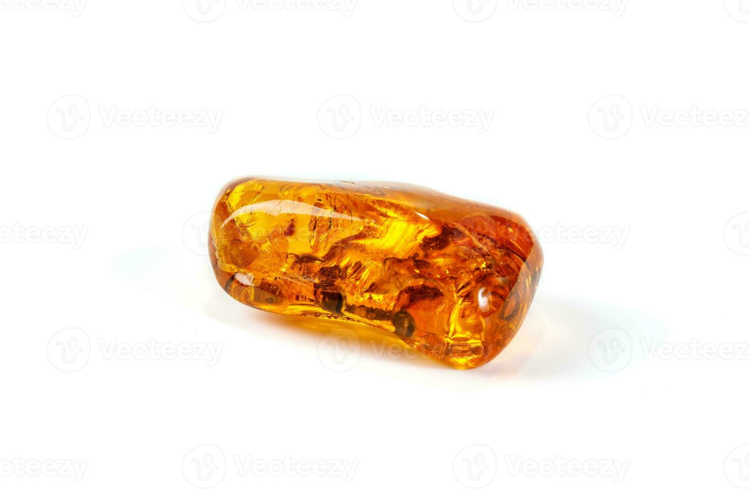 Macro Amber mineral stone with spider on white background photo