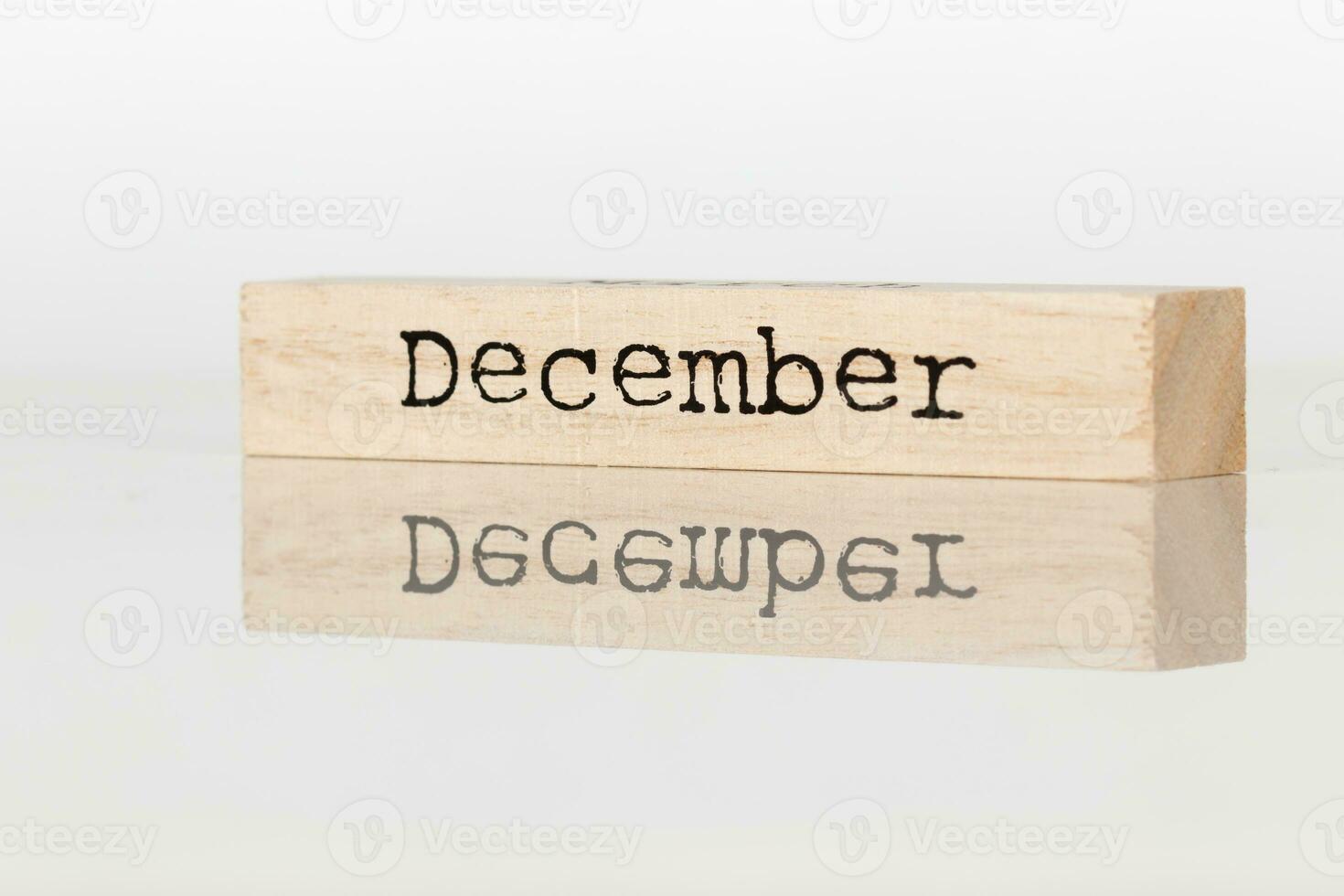 a wooden cube with an inscription December on a white background photo