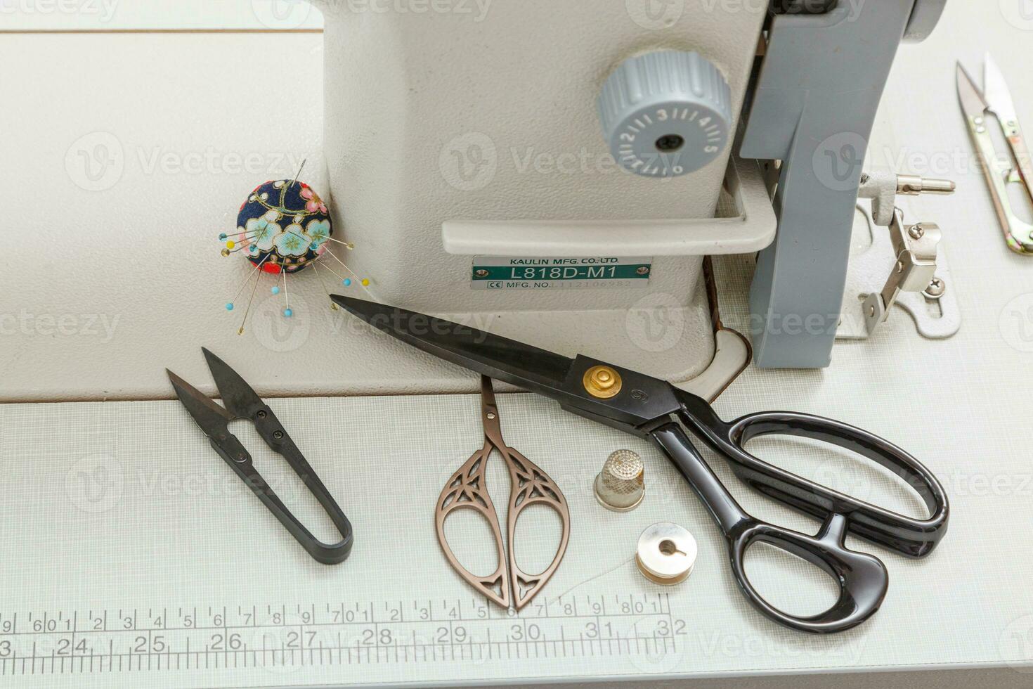 Sewing machine with sewing tools, scissors, threads photo