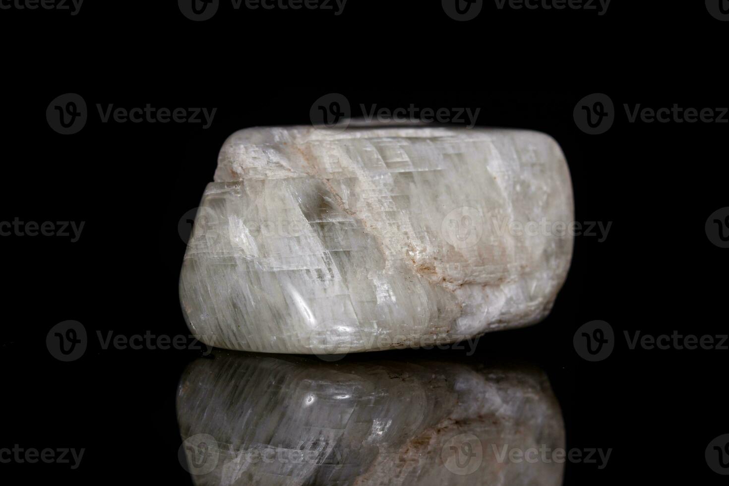 Macro mineral stone Moonstone on black background photo