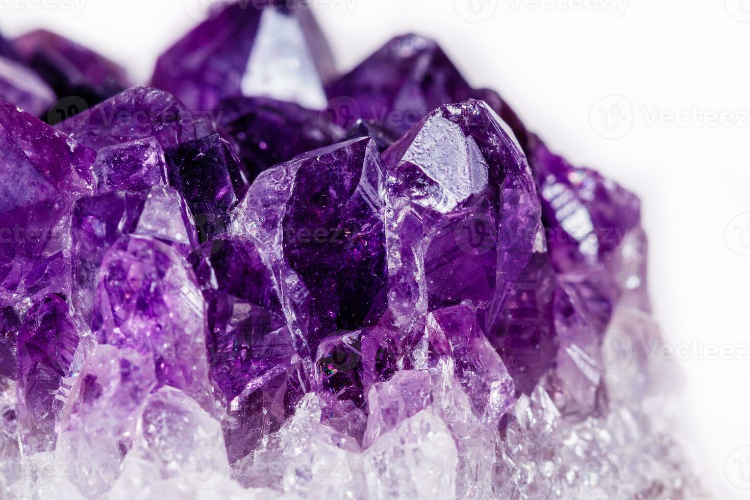 Macro mineral stone purple amethyst in crystals on a white background photo