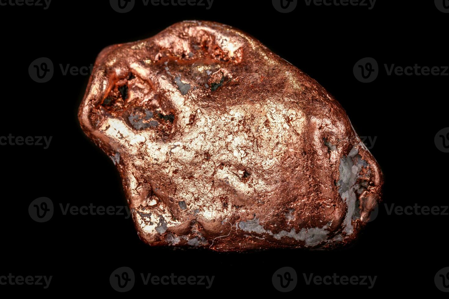 Macro mineral stone of a copper nugget on a microcline on a black background photo