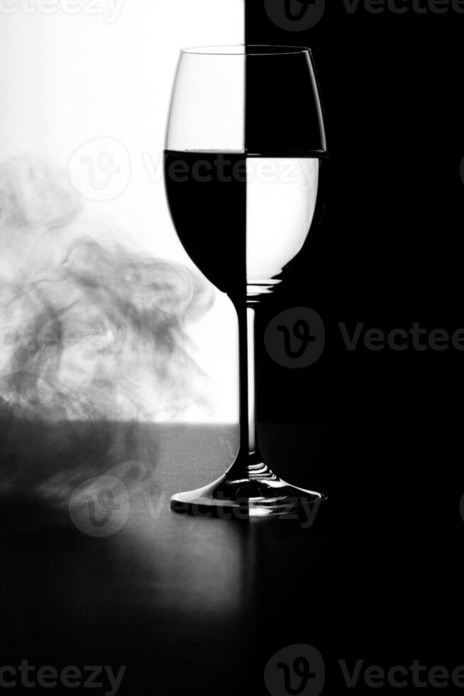 a glass of water and smoke on a black and white background photo