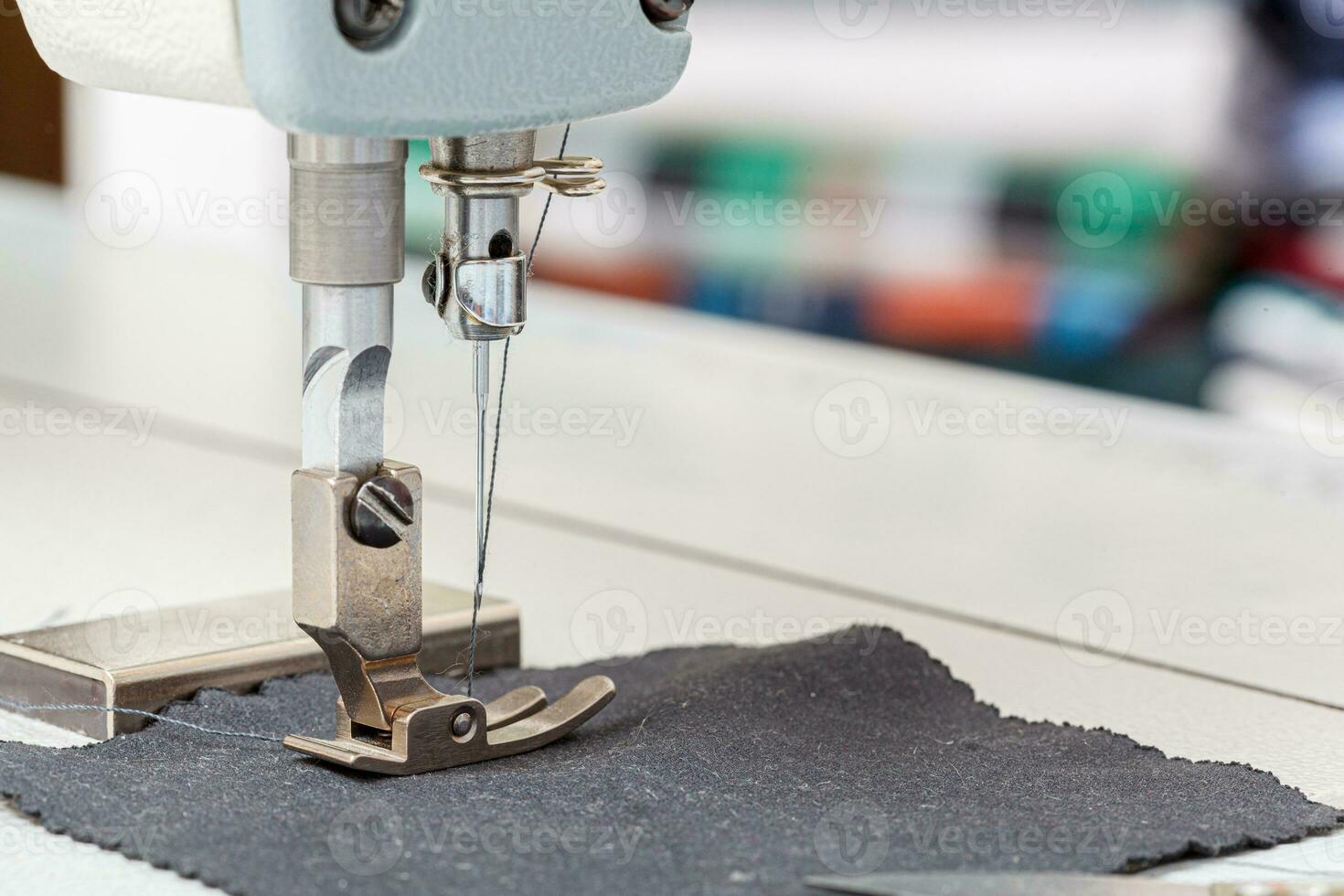 Sewing machine needle with thread and fabric photo